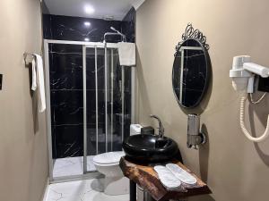 a bathroom with a sink and a toilet and a phone at Centrum Hotel in Ankara +91 photos