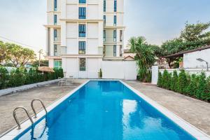 a swimming pool in front of a building at ZAYN Bangna Hotel in Bangna