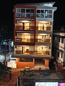 a building under construction at night with lights on at Neelram Hospitality in Mangalore