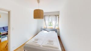 a small room with a white table and a window at Practical Apartment Near Seebach in Zurich
