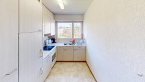 a small kitchen with a sink and a window at Practical Apartment Near Seebach in Zurich