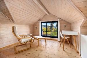 a room with a chair and a desk and a window at Marits Hytte 6p in Vradal