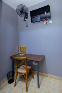 a desk with a fan and a chair and a table at The VIP Luxury CBD in Kisumu +53 photos