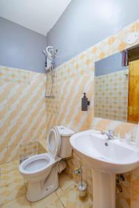 a bathroom with a toilet and a sink at The VIP Luxury CBD in Kisumu