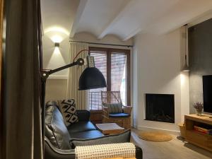 a living room with a chair and a lamp at L' Alzina in Falset +18 photos