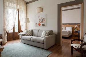 a living room with a couch and a bed at Albergo Le Terme in Bagno Vignoni +115 photos