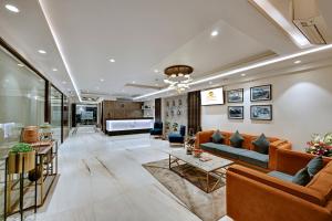 a living room with a couch and a table at Hotel Suba Star Ahmedabad in Ahmedabad