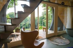 a room with a staircase and a large window at Echo - Baumhaus K1 in Odenthal +18 photos