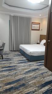 a hotel room with a bed and a chair at بيت سلسبيل- salsbil house in Medina