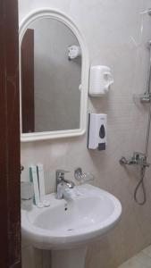 a bathroom with a white sink and a mirror at بيت سلسبيل- salsbil house in Medina