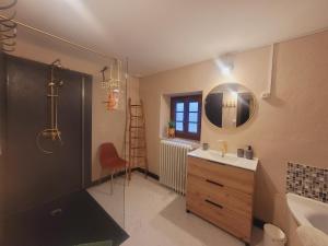 a bathroom with a sink and a toilet and a mirror at Chambre d'hôtes Le Puy Maury in Augne +30 photos