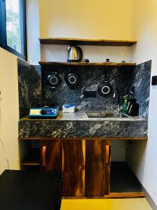 a kitchen counter with a sink in a room at Ancy Villa in Dickwella