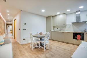a kitchen and dining room with a table and chairs at Pati Blau 2 in Caldes de Malavella +14 photos
