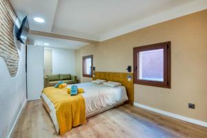 a bedroom with a bed with a teddy bear on it at Pati Blau 2 in Caldes de Malavella