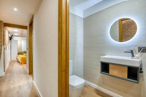 a bathroom with a white toilet and a sink at Pati Blau 2 in Caldes de Malavella