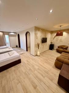 a large room with a bed and a flat screen tv at Solima Pyramids View in Cairo +106 photos
