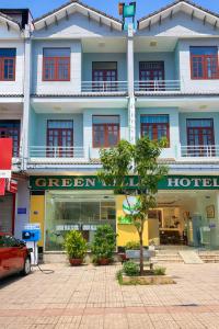 a hotel with a tree in front of it at Green Ville Hotel Đồng Nai in Xa Dau Giay