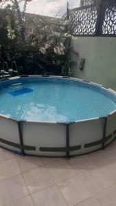 a large swimming pool in a yard with at Villa Regia in Poponguine