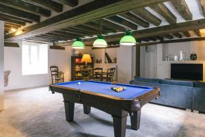 a living room with a pool table in it at Maison d'hôtes le Prieuré du Preux in Sepeaux saint romain