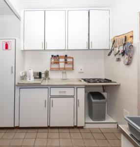 a kitchen with white cabinets and a sink at Estuary Cottage in Sedgefield