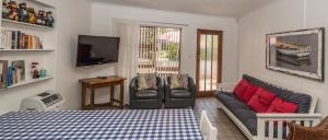 a living room with a couch and a tv at Estuary Cottage in Sedgefield