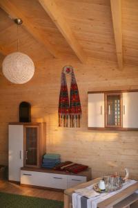 a room with a wooden wall with a table in it at Cabanuta Din Deal in Racoviţa