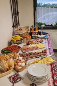 a table topped with lots of different types of food at Cabanuta Din Deal in Racoviţa +13 photos