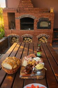 a picnic table with a plate of food and bread at Cabanuta Din Deal in Racoviţa