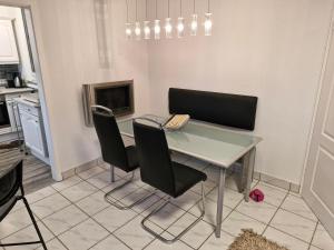 a kitchen with a table and chairs and a fireplace at Ferienwohnung Roersch in Freudenburg