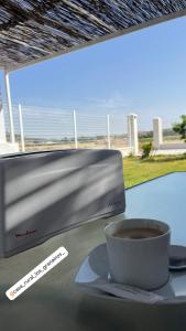 a cup of coffee and a computer monitor on a table at Los Granainos in Arcos de la Frontera