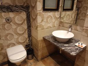 a bathroom with a sink and a toilet at Hotel Varanasi Heritage in Varanasi