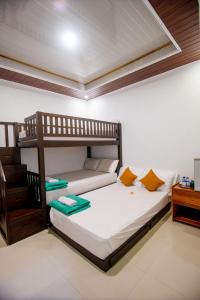 a bedroom with two bunk beds in a room at Eric Dolphin Villa in Lovina