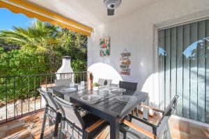 a black table and chairs on a balcony at Villa La Font with pool and bbq in Alicante