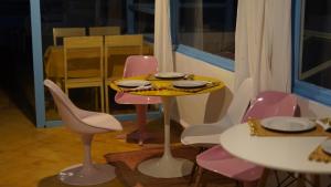 a table with chairs and a yellow plate on it at Riad Dar Afram in Essaouira