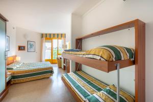 a room with two bunk beds in a room at Hotel Luna in Bibione