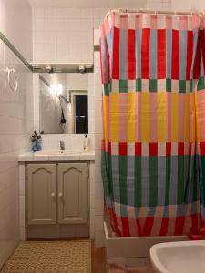 a bathroom with a colorful shower curtain and a sink at Agréables Chambres Centre-Ville Aix in Aix-en-Provence