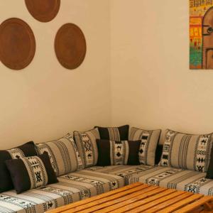 a living room with a couch with pillows on it at Sahara Lounge in Tozeur