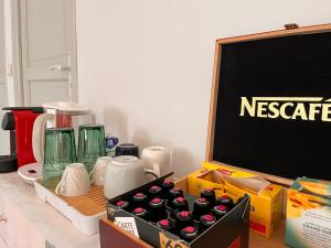 a table with a blackboard and a bunch of bottles at Agréables Chambres Centre-Ville Aix in Aix-en-Provence +4 photos