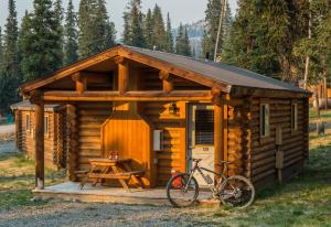 a cabin with a bike parked in front of it at Togwotee Mountain Lodge in Moran