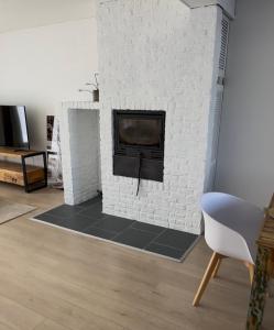 a living room with a white brick fireplace at Antwerp West Side, Fireplace in Zwijndrecht