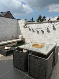 a patio with a table and a couch on a patio at Antwerp West Side, Fireplace in Zwijndrecht