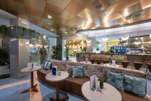 a restaurant with a bar with tables and chairs at Hotel Luna in Bibione