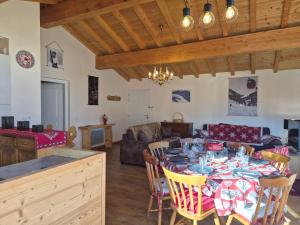 a living room with a table and a couch at Sublime appartement avec terrasse - Centre BSM in Bourg-Saint-Maurice +6 photos