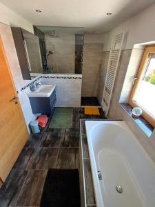 a bathroom with a tub and a sink at Ferienwohnung Bergtroll in Uderns +33 photos