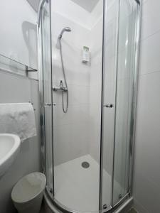 a bathroom with a shower with a toilet and a sink at Contact Hôtel Marseille Aubagne in La Penne-sur-Huveaune