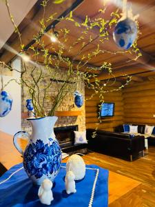 a blue and white vase sitting on a table at Koliba Pod Skalami in Súľov-Hradná
