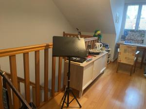 a television on a tripod in a living room at Macasa chambres et table d'hôte in Coolus