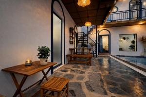 a living room with a table and chairs and a pool at Doc Bien Homestay Mui Ne - Entire Home in Ấp Khánh Phước (1)
