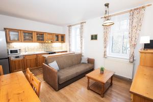 a living room with a couch and a table at Apartmán Černý Důl in Černý Dŭl