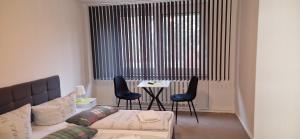 a living room with a couch and a table with chairs at Pension Stechlinsee in Neuglobsow